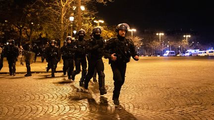 Une unité de gendarmes mobiles à proximité de l'Arc de Triomphe, à Paris, le 14 décembre 2022 après la demi-finale de Coupe du monde entre la France et le Maroc (XIMENA BORRAZAS / MAXPPP)