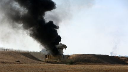 De la fumée s'élève d'une tour d'observation israélienne à Khan Yunis dans les territoires palestiniens, à la frontière avec Israël. (ABED RAHIM KHATIB / DPA)