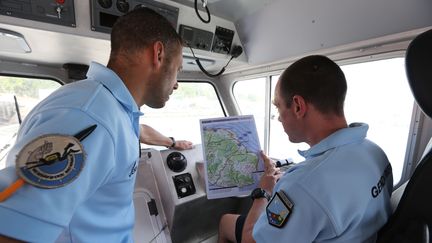 Des membres de la gendarmerie maritime française s'apprêtent à participer&nbsp;aux recherches pour retrouver le MH370, à Sainte-Marie de la Réunion, le 14 août&nbsp;2015. (RICHARD BOUHET / AFP)