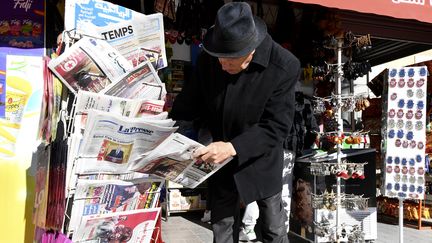 Un Tunisien consulte les journaux sur un stand de l'avenue Habib Bourguiba dans la capitale Tunis le 14 décembre 2021. (FETHI BELAID / AFP)