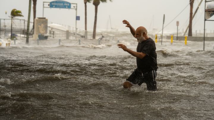 A man walks through a flooded area on the coast of Gulfport, Florida, September 26, 2024, after Hurricane Helene passed through the Gulf of Mexico. (THE WASHINGTON POST / GETTY IMAGES)