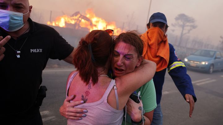 Des habitantes de Varnavas, au nord d'Athènes (Grèce), sont évacuées à cause de l'important feu de forêt qui s'est déclaré le 11 août 2024. (COSTAS BALTAS / AFP)