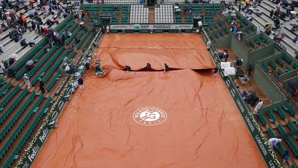 Place aux bâches à Roland-Garros (KENZO TRIBOUILLARD / AFP)