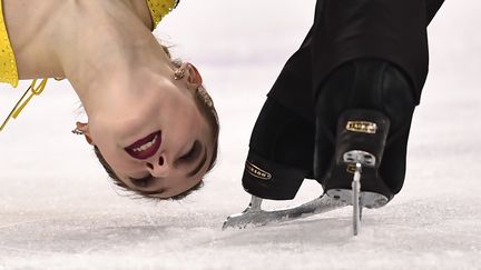 La patineuse russe&nbsp;Kristina Astakhova a la tête en bas et bien proche du patin de son partenaire Alexey Rogonov. Une photo qui rappelle les risques que prennent les patineuses et les patineurs du couple. (ARIS MESSINIS / AFP)