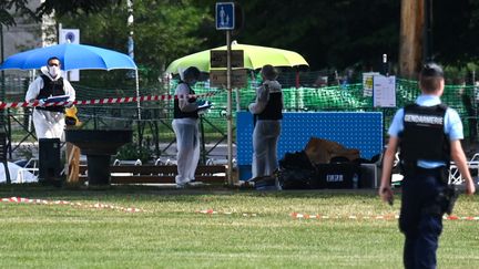 Des membres de la police scientifique sur un des lieux de l'attaque au couteau dans un parc d'Annecy (Haute-Savoie), le 8 juin 2023. (OLIVIER CHASSIGNOLE / AFP)