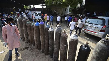 Des Indiens attendent pour remplir des bouteilles d'oxygène médical pour des patients atteints du Covid-19 à Allahabad, dans le nord-est du pays. (SANJAY KANOJIA / AFP)