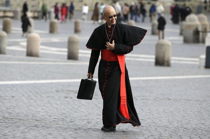 Le cardinal chinois John Tong Hon&nbsp;a agr&eacute;ment&eacute; sa soutane noire ajust&eacute;e d'une touche de modernit&eacute; avec des lunettes de soleil &agrave; fines branches et une serviette en cuir.&nbsp;Au Vatican, le 8 mars 2013.&nbsp; (MAX ROSSI / REUTERS)