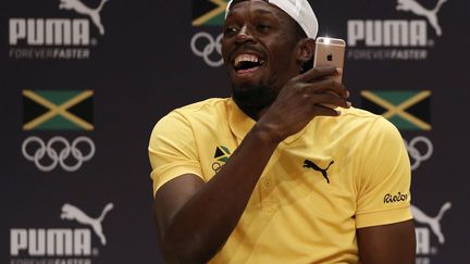 Usain Bolt lors de la conférence de presse jamaïcaine (ADRIAN DENNIS / AFP)