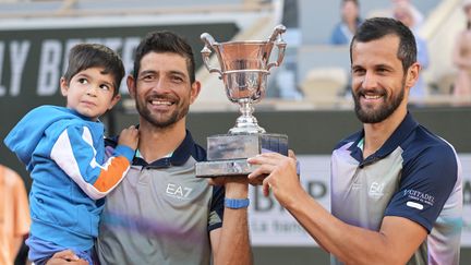 Marcelo Arevalo et Mate Pavic célèbrent leur victoire dans le double hommes de Roland-Garros. (BERTRAND GUAY / AFP)