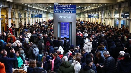 Des passagers patientent à la gare Saint-Pancras à Londres, le 30 décembre 2023, alors que tous les trains Eurostar au départ et à destination de la gare sont annulés. (HENRY NICHOLLS / AFP)