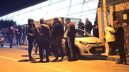 Des badauds devant le gymnase Massenet de Marseille (Bouches-du-Rhône), dimanche 29 décembre 2019, où un probable réglement de comptes a fait un mort. (MAXPPP)