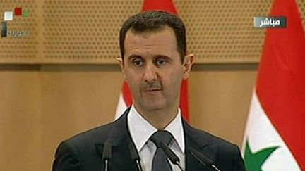 Bachar Al-Assad, le pr&eacute;sident syrien, lors d'un discours &agrave; la nation depuis l'universit&eacute; de Damas, le 20 juin 2011. (SYRIAN TV / AFP)