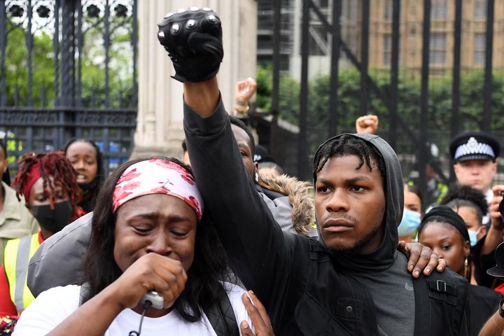 John Boyega, poing levé parmi d'autres manifestants de la marche de protestation sur le thème "Black Lives Matter", le 3 juin 2020 à Londres, après la mort de l'Afro-Américain George Floyd, tué&nbsp;lors de son interpellation à Minneapolis quelques jours plus tôt (DANIEL LEAL-OLIVAS / AFP)