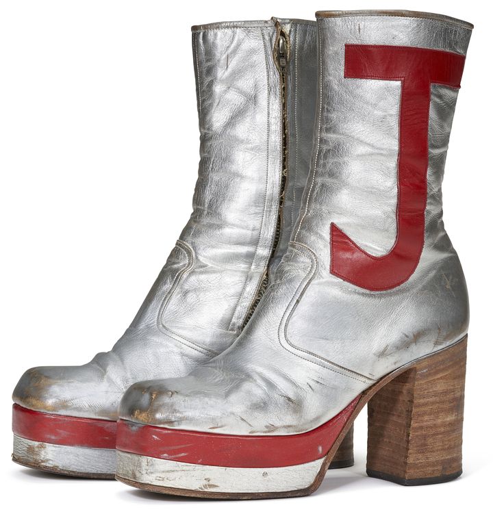 Une paire de bottes en cuir argent avec les lettres "E" et "J" en cuir rouge sur les côtés. Ces plateformes à rayures rouges et blanches ont été portées lors de nombreuses représentations d'Elton John tout au long des années 1970. (CIRCA 71)