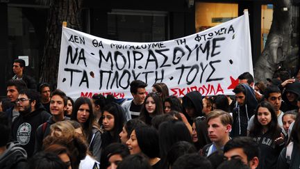 Des lyc&eacute;ens manifestent &agrave; Nicosie (Chypre) avec une banderole sur laquelle est inscrit&nbsp;"Nous ne partageons pas la pauvret&eacute;, nous devons partager leur richesse", le 26 mars 2013. (EMILY IRVING-SWIFT / AFP / BFMTV)