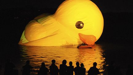 Des spectateurs regardent se gonfler le canard en plastique de l'artiste n&eacute;erlandais&nbsp;Florentijn Hofman lors de son installation &agrave; P&eacute;kin (Chine), le 25 septembre 2013. (REUTERS)