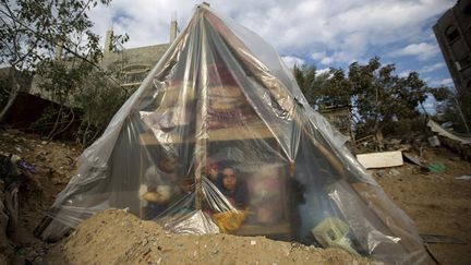 Une famille de Palestiniens a trouv&eacute; refude sous une tente de fortune apr&egrave;s que leur maison a &eacute;t&eacute; inond&eacute; dans la bande de Gaza (Palestine), le 17 d&eacute;cembre 2013. (MOHAMMED ABED / AFP)