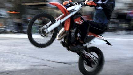 Un motard fait une roue arrière en milieu urbain. Photo d'illustration. (LIONEL VADAM / MAXPPP)