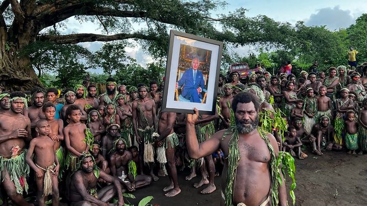 Des villageois de Iaohnanen et Yakel, sur l'île de Tanna au Vanuatu, posent avec un portrait du roi Charles III, le 6 mai 2023. (BEN BOHANE / AFP)