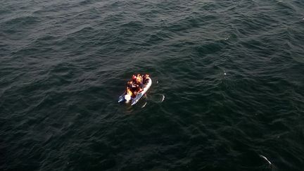 Des migrants à bord d'une embarcation semi-rigide, le 24 juillet 2019, dans la Manche, au large de Calais. (PREFECTURE MARITIME DE LA MANCHE / AFP)