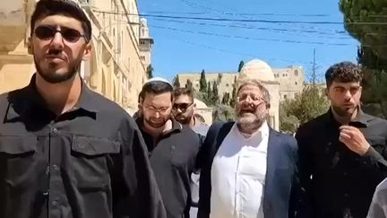 Israeli Security Minister Itamar Ben Gvir sings at the mosque compound in Jerusalem on August 13, 2024. (AFP / UGC / ANONYMOUS)