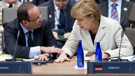 François Hollande et Angela Merkel, lors du sommet de l'OTAN. (SAUL LOEB / AFP)