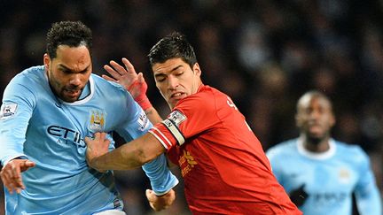 Joleon Lescott et Luis Suarez au duel lors du match aller entre Manchester City et Liverpool (2-1). (PAUL ELLIS / AFP)