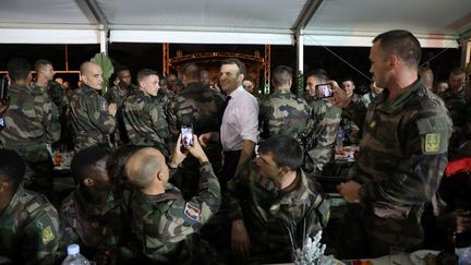 Le président français Emmanuel Macron, le 21 décembre 2019, lors du dîner de Noël avec les troupes françaises basées en Côte d'Ivoire. (LUDOVIC MARIN / AFP)