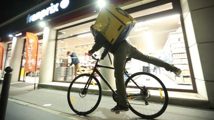 Un livreur à vélo dans le 15e arrondissement de Paris, en novembre 2018. Photo d'illustration.&nbsp; (PHILIPPE LAVIEILLE / MAXPPP)