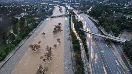 Aerial view of the Los Angeles River swollen by runoff, February 5, 2024, in California.  (MARIO TAMA / GETTY IMAGES NORTH AMERICA / AFP)