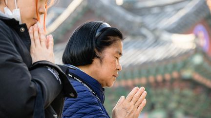 Families traditionally spend the day praying on the day of their children's trials.  (ANTHONY WALLACE / AFP)