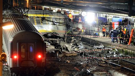 Le secours&nbsp;travaillent de nuit sur le site d'un accident de train survenu le 12 juillet 2013 à la gare de Bretigny-sur-Orge&nbsp;(Essonne).&nbsp;Plusieurs voitures d'un train Intercités reliant Paris-Austerlitz à Limoges-Bénédictins ont déraillé en raison de la défaillance d'une éclisse, entraînant la mort de sept personnes. (LIONEL BONAVENTURE / AFP)