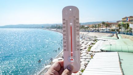 Un thermomètre devant une plage à Nice, le 16 juillet 2023. (ROLAND MACRI / HANS LUCAS)