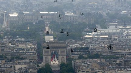 Des h&eacute;licopt&egrave;res de l'arm&eacute;e fran&ccedil;aise d&eacute;filent lors des c&eacute;l&eacute;brations du 14-Juillet &agrave; Paris, le 14 juillet 2014. (PHILIPPE WOJAZER / REUTERS)