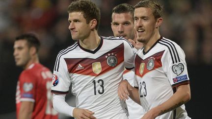 Les joueurs allemands Thomas Muller, Max Kruse et Lukas Podolski 