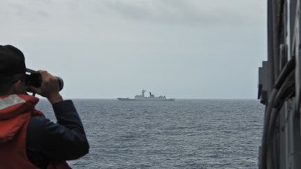 A Taiwanese navy sailor monitors a Chinese navy warship off the coast of Taiwan, August 19, 2023. (TAIWAN MINISTRY OF NATIONAL DEFENSE / AFP)