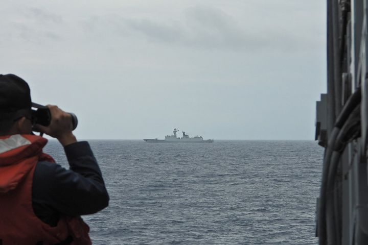 A Taiwanese navy sailor monitors a Chinese navy warship off the coast of Taiwan, August 19, 2023. (TAIWAN MINISTRY OF NATIONAL DEFENSE / AFP)