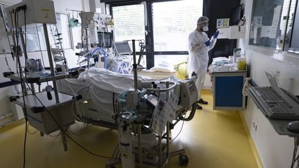 Un infirmier s'occupe d'un patient malade du Covid-19 au service de soins intensifs de l'Institut Mutualiste Montsouris, à Paris, le 21 avril 2021. (THOMAS SAMSON / AFP)