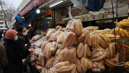 Des femmes achètent du pain sur un marché d'Ankara, le 20 décembre 2021.&nbsp; (ADEM ALTAN / AFP)