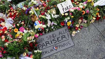 «Nous sommes tous des Parisiens», «Berlin aime Paris» lit-on sur cette pancarte placée devant l'ambassade de France en Allemagne. (JOHN MACDOUGALL / AFP)