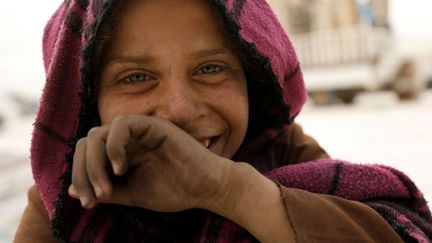 L'information qui accompagne cette photo ne donne ni le nom ni l'âge de cette petite fille syrienne qui sourit devant l'objectif. Une «déplacée» anonyme, comme des dizaines de milliers d'autres. On sait simplement qu'elle vit dans ce camp «temporaire» situé à 55 kilomètres de sa ville de Raqa qui est sous le joug de l'organisation Etat islamique depuis 2014. Près de 300 familles syriennes et irakiennes vivent dans ce camp en espérant pouvoir un jour rentrer chez eux.  (Rodi Said / Reuters)