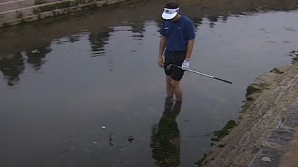 Le golfeur Jean Van de Velde, pieds nus dans un ruisseau pour "sortir" sa balle lors du 18e trou au British Open 1999. (CAPTURE D'ÉCRAN YOUTUBE)