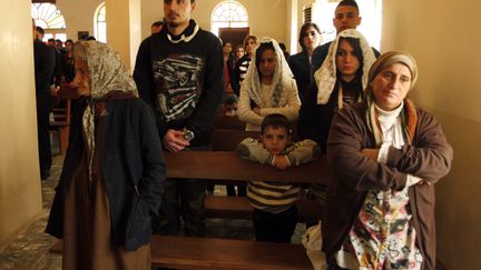 Des Chr&eacute;tiens d'Irak assistent &agrave; la messe de No&euml;l &agrave; Bagdad (Irak). (© AHMED SAAD / REUTERS / X03357)