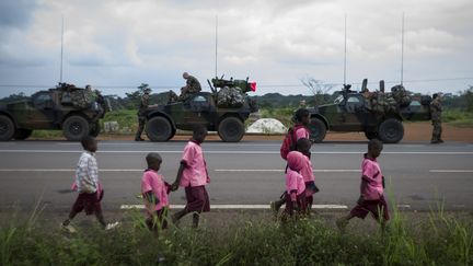 Des enfants marchent le long d'une route camerounaise, alors que les troupes fran&ccedil;aises se positionnent pr&egrave;s de la fronti&egrave;re avec la Centrafrique, le 5 d&eacute;cembre 2013. (FRED DUFOUR / AFP)