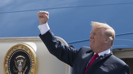 Le président américain Donald Trump envoie son poing à la foule alors qu'il arrive à la base commune Ellington Field à Houston, au Texas, le 31 mai 2018. (JIM WATSON / AFP)