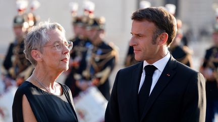 Elisabeth Borne et Emmanuel Macron le 14 juillet 2023. (LUDOVIC MARIN / AFP)