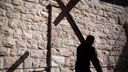 Un pénitent chrétien porte la croix tout le long de la Via Dolorosa dans la vieille ville de Jérusalem, pour la procession du vendredi saint, le 25 mars 2016. (Galli Tibbon)