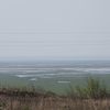 Une vue du réservoir asséché de Kakhovka (Ukraine), le 10 avril 2024, depuis la ville de Kamianka-Dniprovska, occupée par l'armée russe. (ALEXANDER POLEGENKO / TASS / SIPA)