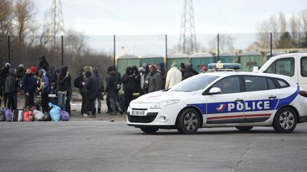 Un véhicule de police à proximité d'un groupe de migrants à Calais, le 2 février 2018.&nbsp; (PHILIPPE HUGUEN / AFP)