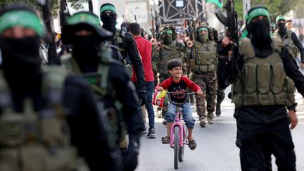 Un enfant au milieu d'un défilé militaire du Hamas à Gaza, le 22 mai 2021. (EMMANUEL DUNAND / AFP)